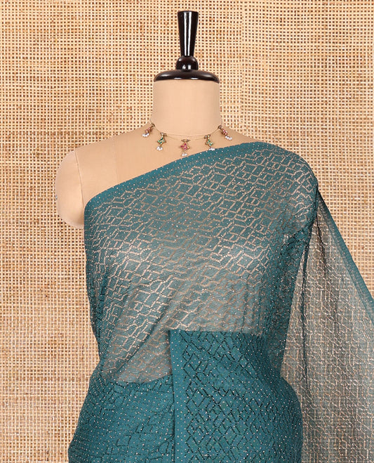 Borderless green sparkling glitter russel net saree with self-pallu, and a contrast floral printed and zig-zag patterned blouse