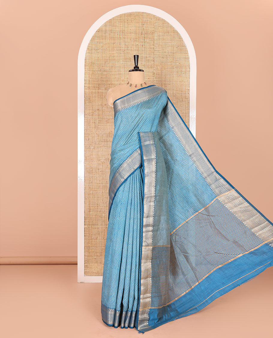 Blue Semi-Tussar Saree Accentuated with Zig-Zag Strips Prints, Featuring a Self-border with Traditional Motifs, a Zari-Striped Pallu, Paired with a Matching Blouse