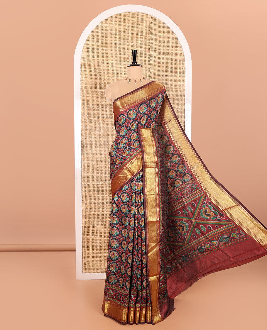 Black Patola Saree Adorned with Ikkat-Style Buttas Enclosed Round Design, Complemented by a Contrast Traditional Zari Design Border, Featuring Intricate Ikkat Style Pallu, and Paired with a Contrast Blouse