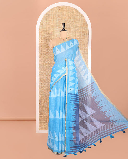Blue Linen Saree Prettified with Triangle Patterns Print, and Mirror Work All Over Its Body, Subtle Zari Piping Border, Contrast Pallu Mirrors the Same Print, and Paired with a Printed Blouse