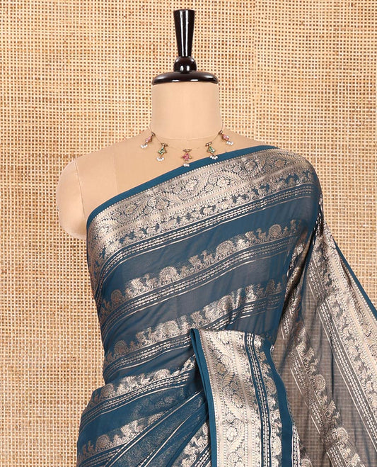Blue Georgette Saree, Adorned with Zari Peacock Designs All Over Its Body, Highlighted by a Traditional Zari Border, Gracefully Zari-Decked Pallu, and Paired with a Matching Brocade Blouse