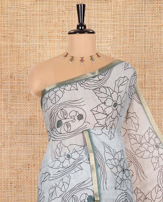 Light Green Linen Saree Creatively Printed with Girl Face and Floral Motifs All Over Its Body, Subtly Sparkled with Piping Zari Border, Pallu Mirrors the Same Body Print, and Paired with a Contrast Blouse