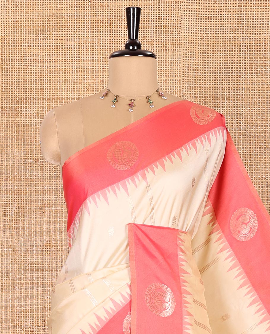 Cream Elite Soft Silk Saree, Beautified with Zari Buttas and Zari Stripes All Over Its Body, Complemented by a Contrast Temple Border of Round Peacock Designs, Rich Pallu of Peacock Chakram Butta Enclosed Checks, and Paired with a Contrast Blouse
