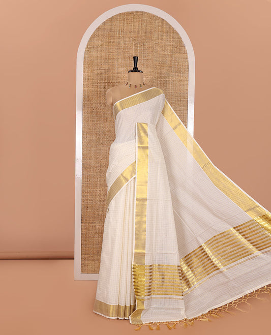 Cream Kerala Cotton Saree, Enthralled with Small-Sized Checks All Over Its Body, Subtle Bavanji Border, Scintillating Zari Design Pallu, and Paired with a Matching Blouse