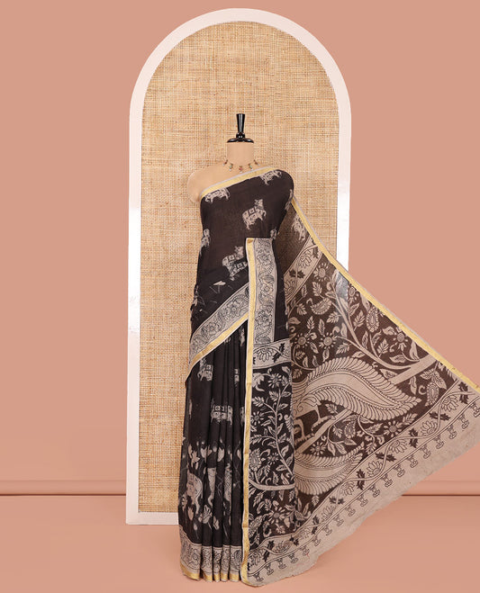 Black Kota Cotton Saree, Artfully Printed with Pichwai Cow Motifs on Its Body, Complemented by Contrast  Border of Floral Creeper Print, Pallu Pictures Kalamkari Peacock and Floral Designs, and Paired with a Contrast Floral Printed Blouse