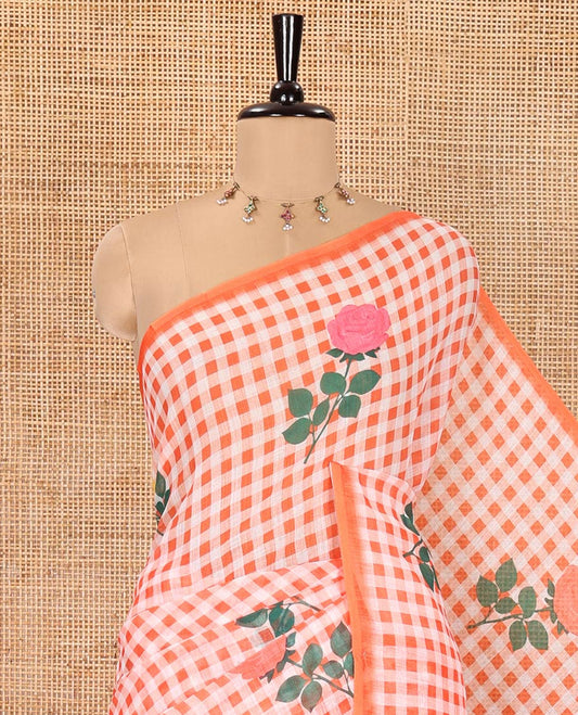 Borderless Orange Linen Cotton Saree, Elevated with Rose Floral Buttas and Checked Design on Its Body, Pallu Pictures a Beautiful Rose Floral Motifs, and Paired with a Matching Blouse