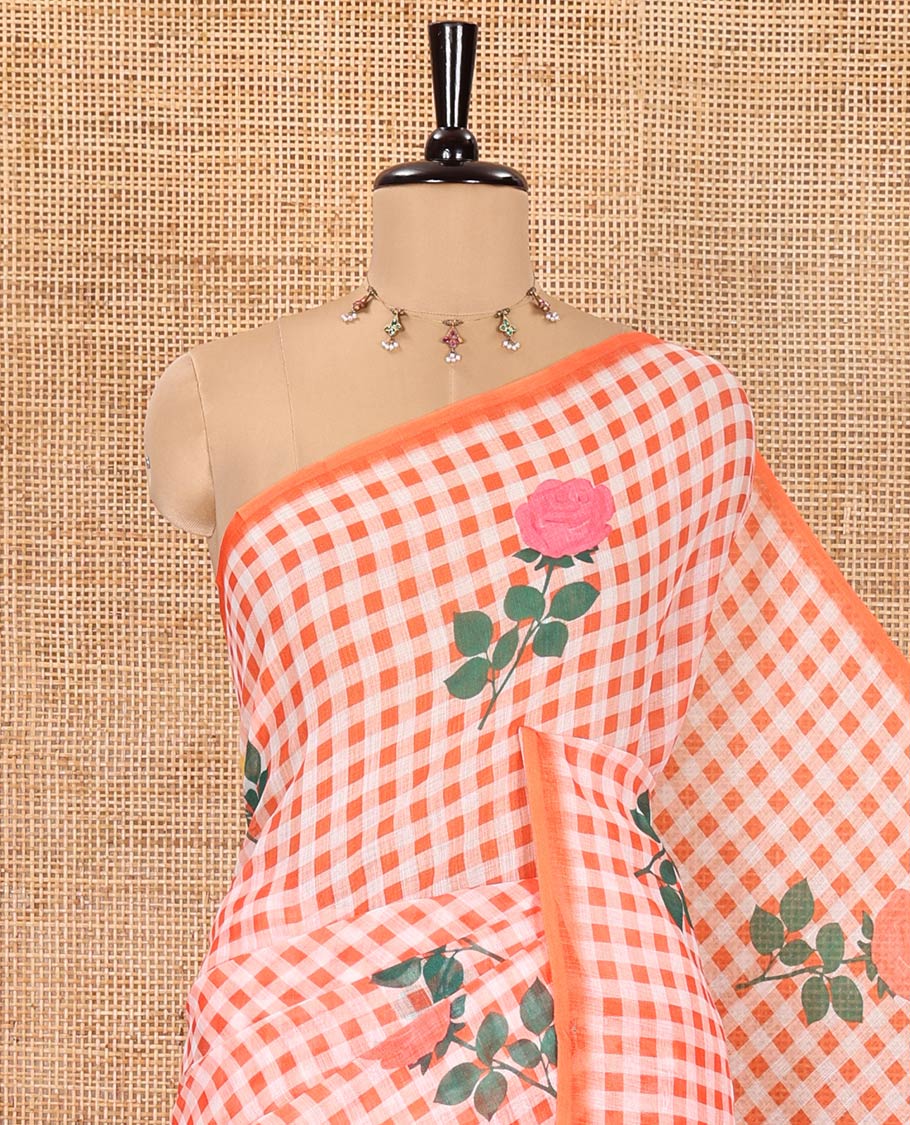 Borderless Orange Linen Cotton Saree, Elevated with Rose Floral Buttas and Checked Design on Its Body, Pallu Pictures a Beautiful Rose Floral Motifs, and Paired with a Matching Blouse