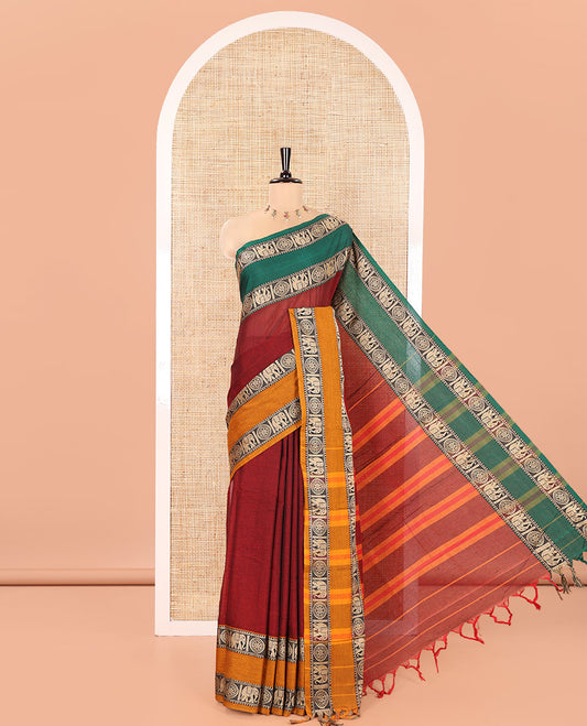 Maroon Plain Mercerised Cotton Saree, Complemented by a Contrast Ganga-Jamuna Rettai Pettu Thread Border of Temple, Elephant, and Chakram Designs, Subtly Striped Pallu, and Paired with a Matching Blouse