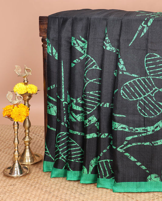 Black with green geomentrical design khadhi silk saree with contrast striped border & geomentrical print pallu along with printed blouse