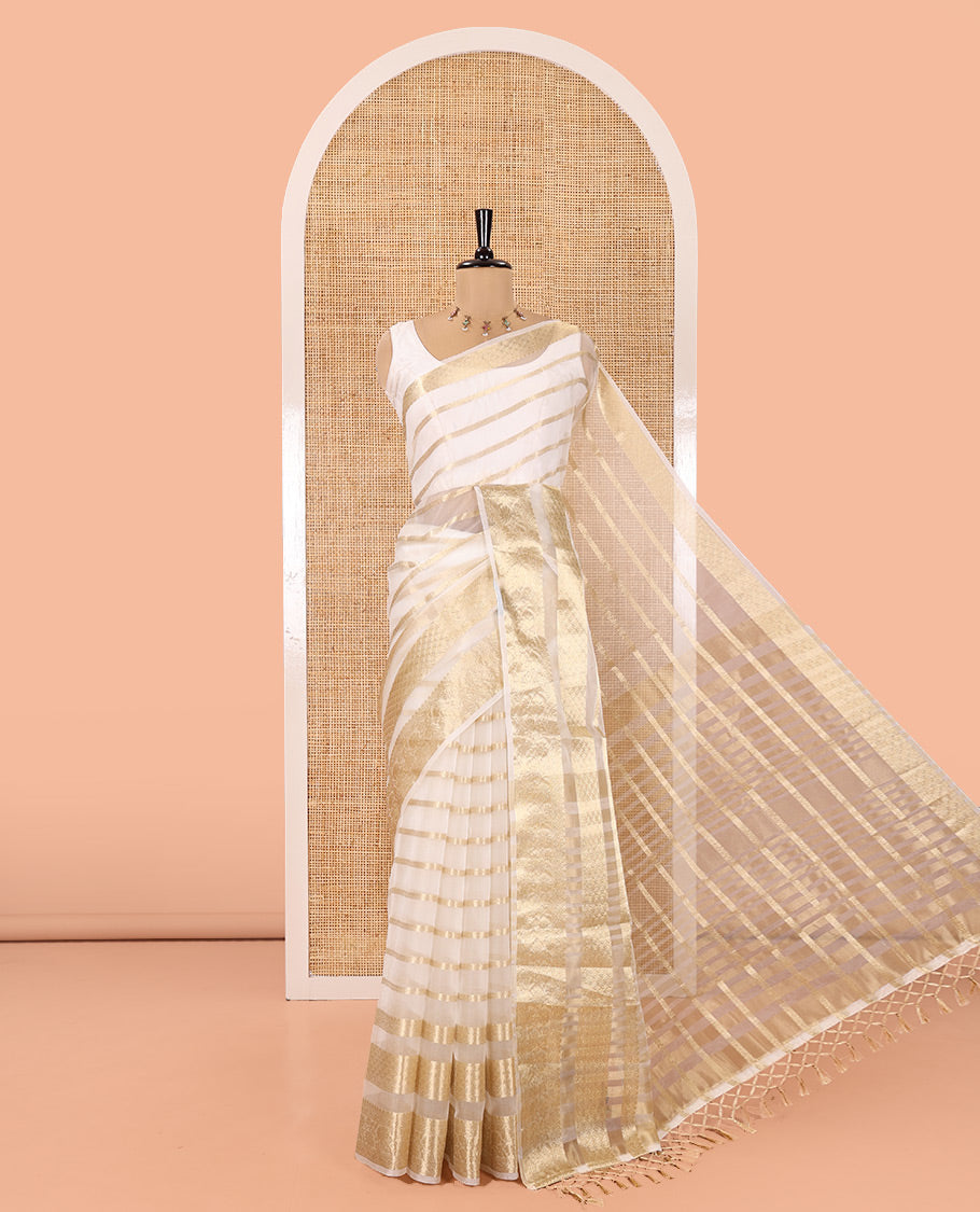 Cream Semi-Organza Saree, Gleamed Up with Zari Stripes All Over Its Body, Highlighted by a Traditional Zari Design Border, Gleaming Zari Striped Pallu, and Paired with a Matching Blouse