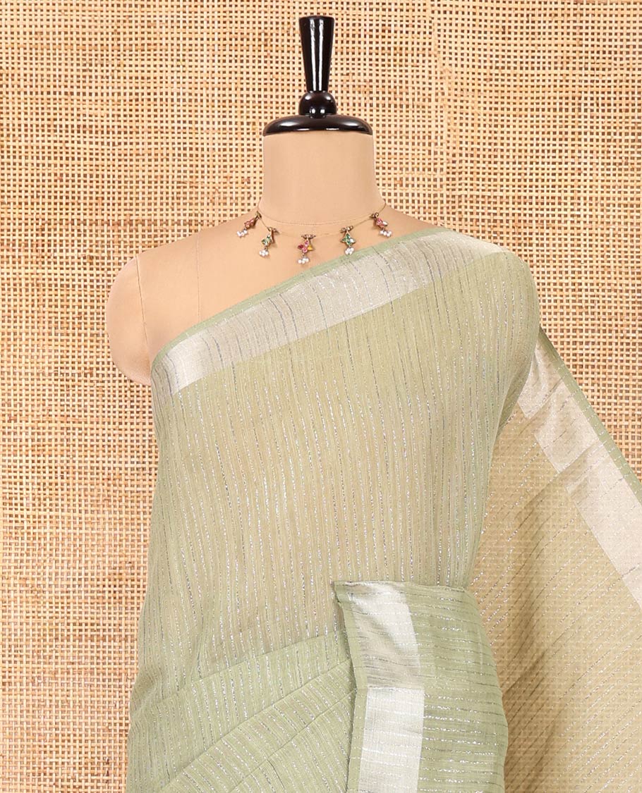 Sage Green Linen Zari Cotton Saree, Gleamed Up with Zari Stripes All Over Its Body, a Subtle Zari Border, a Self-Pallu, and Comes Without a Blouse