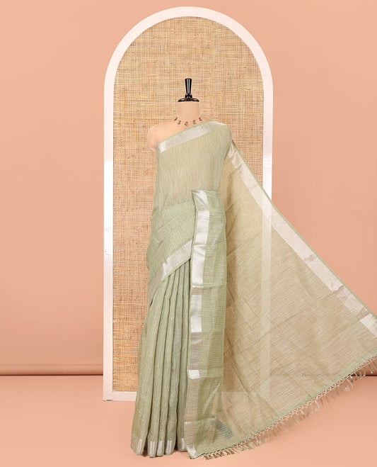 Sage Green Linen Zari Cotton Saree, Gleamed Up with Zari Stripes All Over Its Body, a Subtle Zari Border, a Self-Pallu, and Comes Without a Blouse