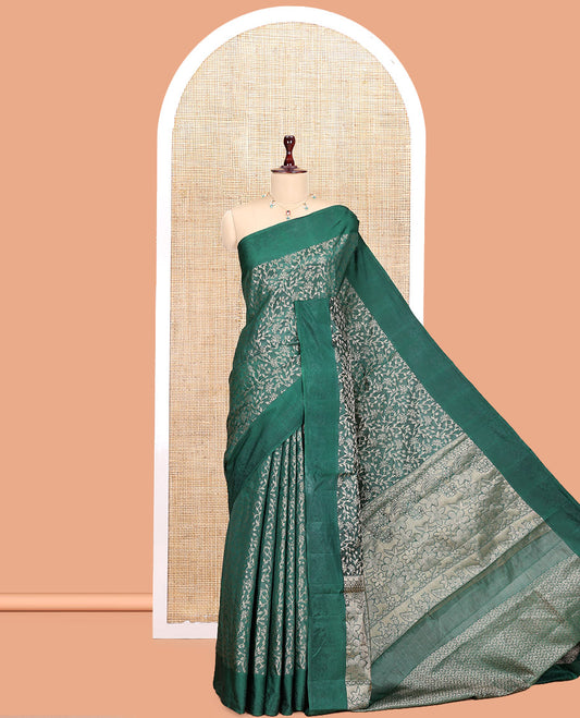 Green Semi-Tussar Saree, Ornamented with Floral Jacquard Design, an Embossed Border, a Floral Pallu, and a Matching Blouse