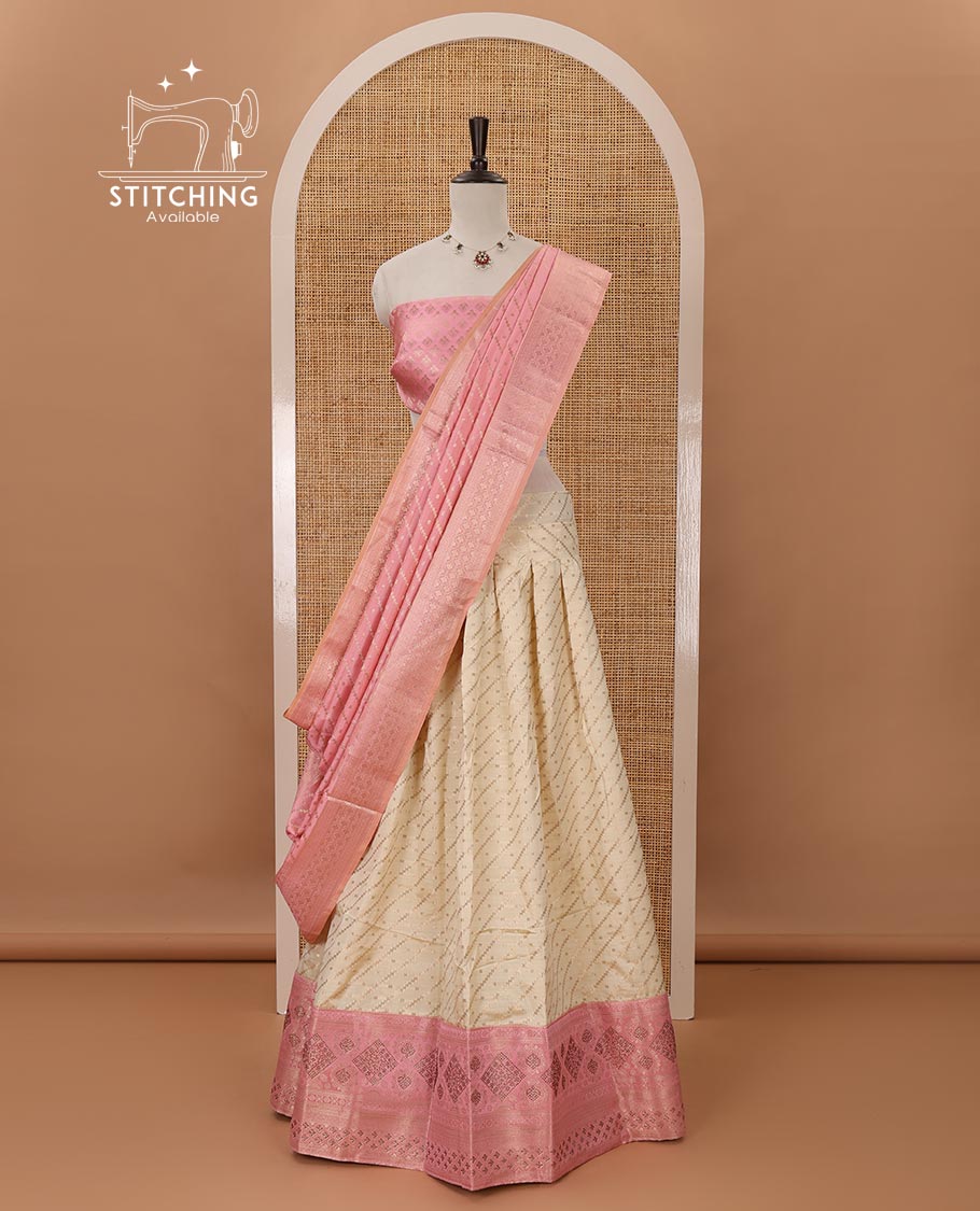 Cream semi-banaras half saree,leheriya zari skirt,contrast onion pink zari & swarovski stonework border,jacquard blouse & zari weave dhavani