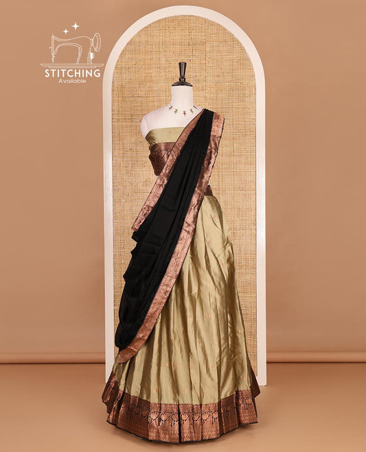 Brown taffeta silk half saree, zari buttas with contrast black traditional zari border skirt, matching zari design blouse, and contrast plain zari border syska georgette dhavani