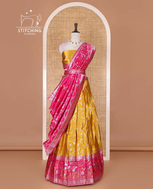 Haldi yellow taffeta silk half saree, floral jaal jacquard skirt, contrast rani zari meenakari style bird border, matching blouse, and floral jaal dhavani