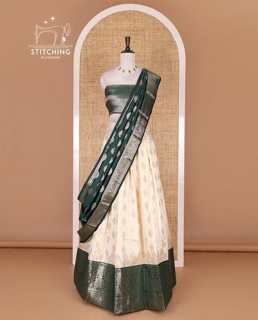 Cream with bottle green semi-banarasi half-saree, zari buttas with contrast traditional zari border skirt, zari jacquard blouse, and zari design dhavani