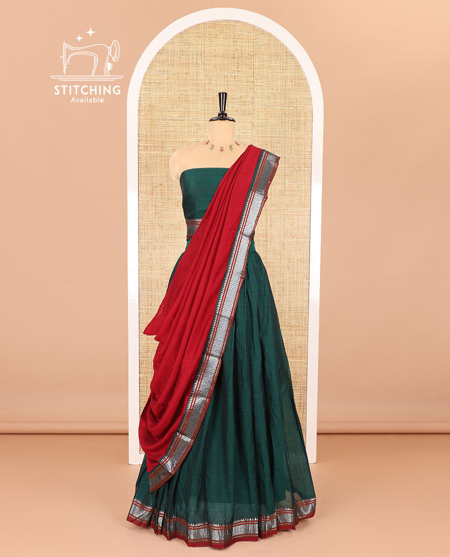 Dark green half-saree, plain with contrast traditional zari bordered skirt, matching blouse, and contrast zari border dhavani