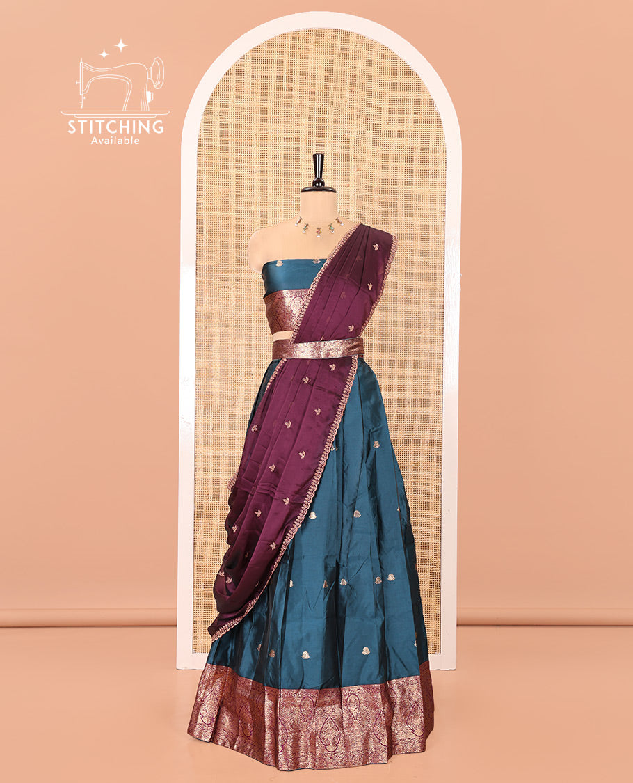 Peacock Blue and Magenta Semi-Banarasi Half-Saree, Accentulated with Zari Buttas on Its Skirt, Complemented by a Contrast Intricately Zari-Designed Border, Paired with a Matching Blouse, and a Contrast Satin Georgette Embroidered Scallop Dhavani