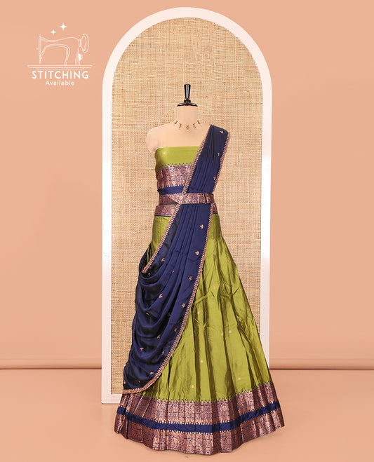Parrot Green and Blue Semi-Banarasi Half-Saree, Accentuated with Zari Buttas on Its Skirt, Complemented by a Contrast Rettai Pettu Traditional Zari-Design Border, Paired with a Matching Blouse, and Comes with a Contrast Satin Georgette Embroidered Dhavani