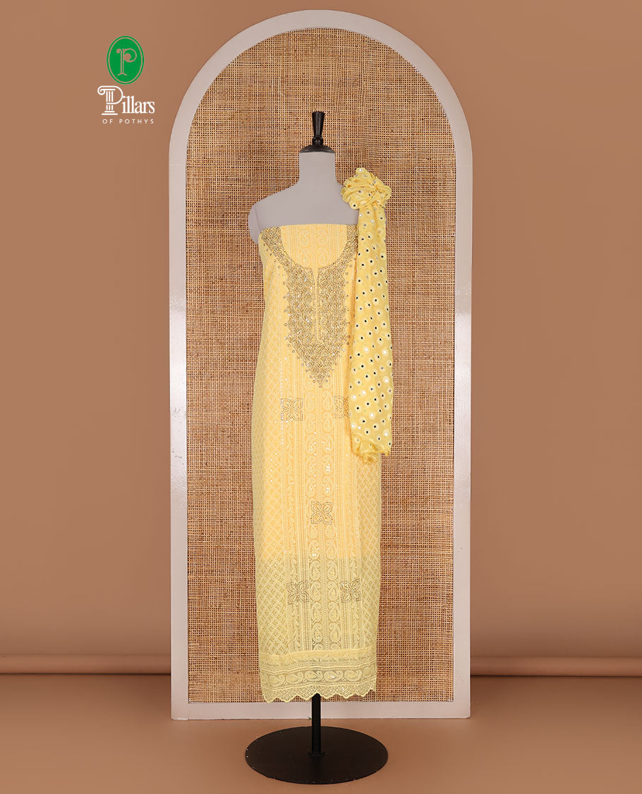 Yellow material churidar set, stone work with Schiffli style embroidered georgette top, American Crape bottom, and polka dotted printed mirror work dupatta