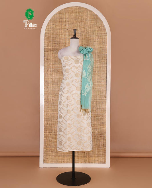 Cream with blue semi-chanderi material churidar set, floral jaal jacquard top, contrast taffeta silk bottom, and jamdani style dupatta