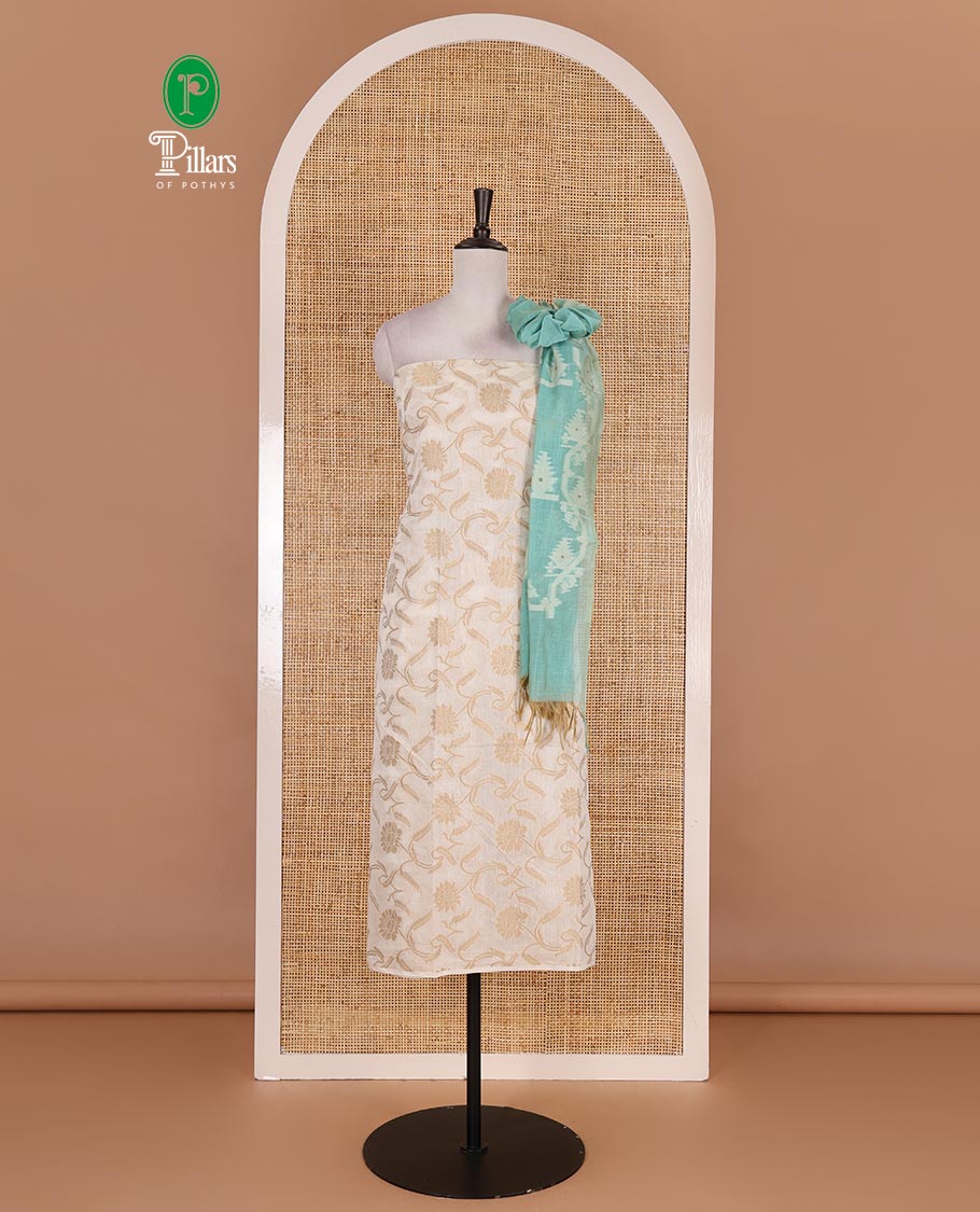 Cream with blue semi-chanderi material churidar set, floral jaal jacquard top, contrast taffeta silk bottom, and jamdani style dupatta