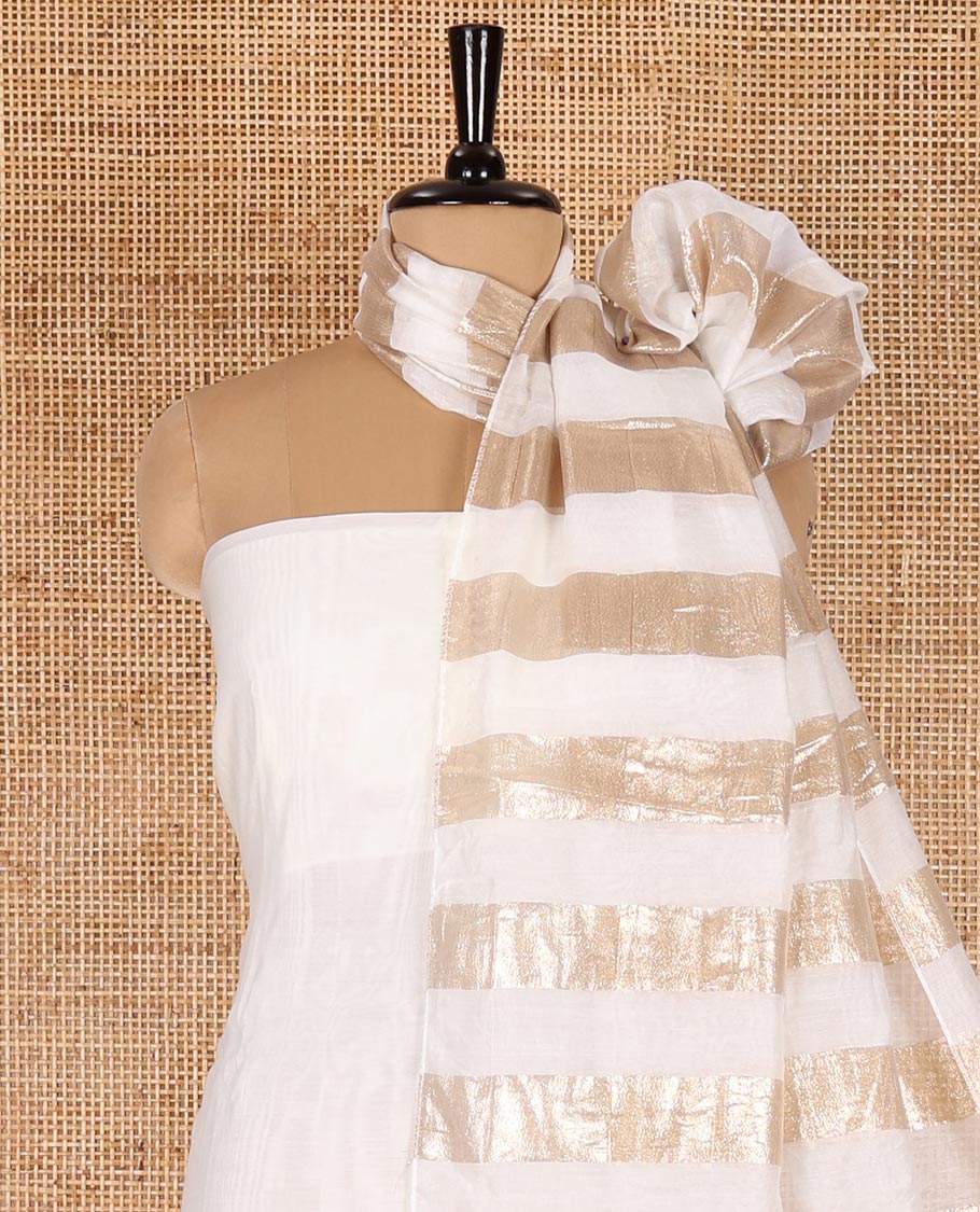 White material chudidar set, plain with pom-pom tasseled mul chanderi top, a matching bottom, and organza dupatta of stripes