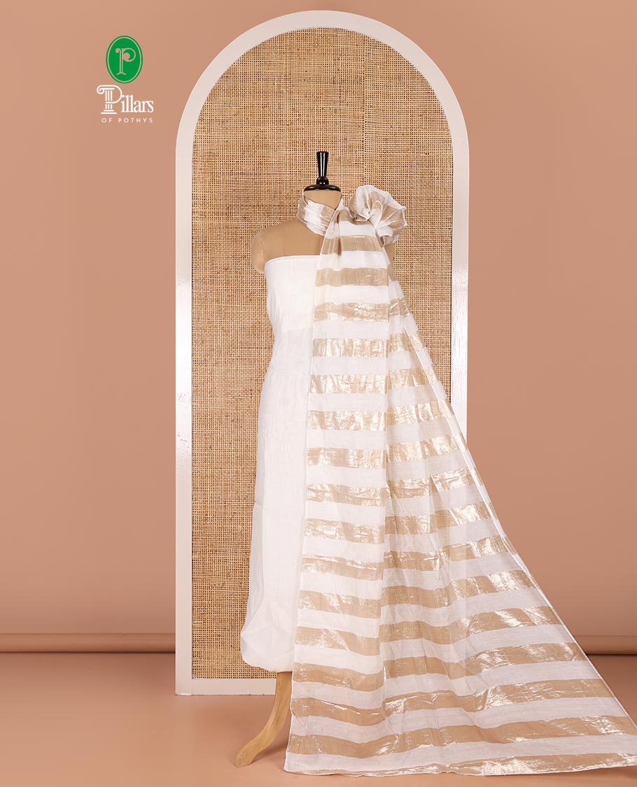 White material chudidar set, plain with pom-pom tasseled mul chanderi top, a matching bottom, and organza dupatta of stripes