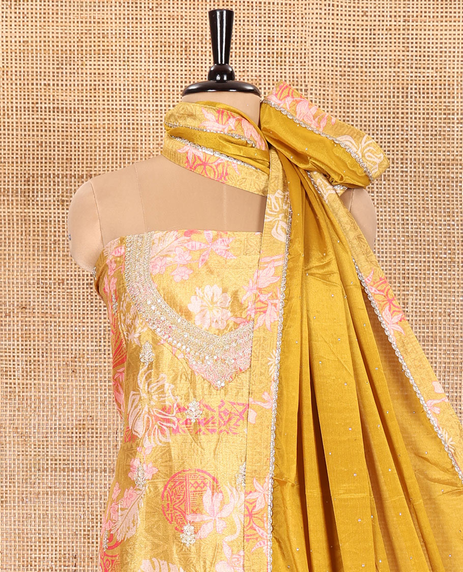Mustard Material Chudidar Set Elevated with Floral-Geometric Printed with Neck Embroidered Chinon Top, Subtly Made Plain Santoon Bottom, and a Chinon Dupatta Featuring Printed Border, and Glitter Dots