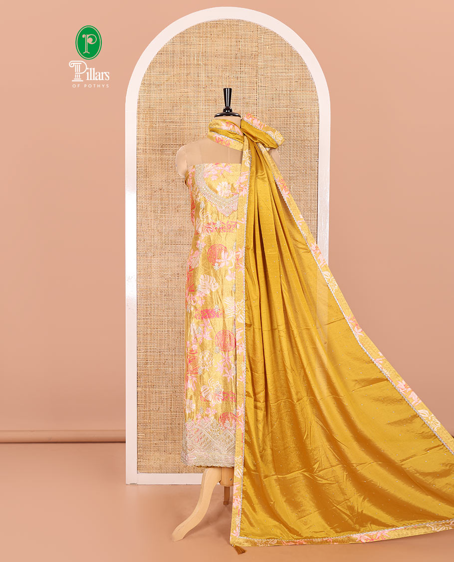 Mustard Material Chudidar Set Elevated with Floral-Geometric Printed with Neck Embroidered Chinon Top, Subtly Made Plain Santoon Bottom, and a Chinon Dupatta Featuring Printed Border, and Glitter Dots