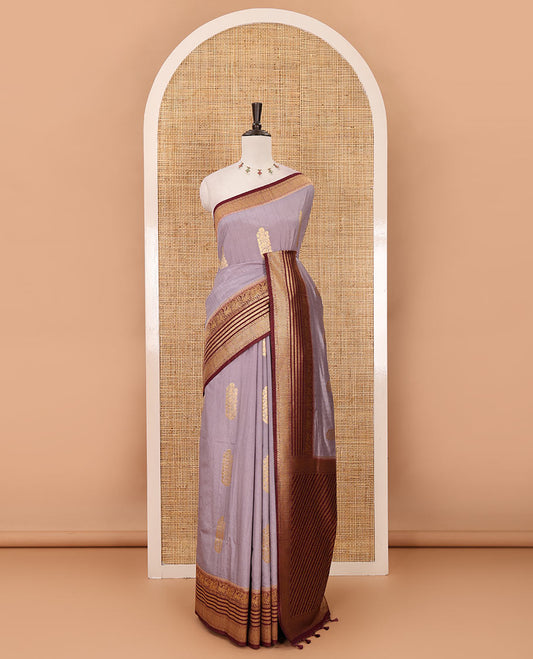 Light lavender floral zari buttas dola silk saree, contrast traditional zari peacock border, diagonal floral zari striped pallu & contrast jacquard blouse