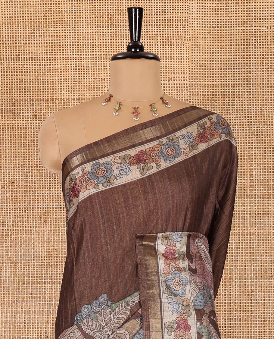 Brown kalamkari human figurines printed fancy tussar saree, floral printed border, human figurines printed pallu, and a matching blouse