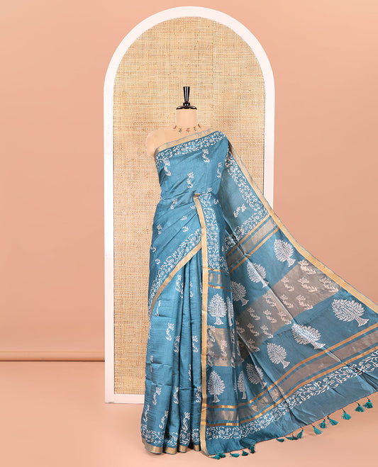 Blue Banana Pith Saree Graced with Floral Motifs Discharge Print All Over Its Body, Zari Bavanji Border, Pallu Subtly Woven in Floral-Tree Print and Zari Weave, and Paired with a Matching Blouse