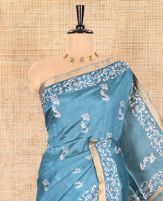 Blue Banana Pith Saree Graced with Floral Motifs Discharge Print All Over Its Body, Zari Bavanji Border, Pallu Subtly Woven in Floral-Tree Print and Zari Weave, and Paired with a Matching Blouse