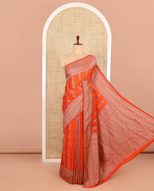 Orange Fancy Khaddi Georgette Elevated with Geometric Patterns in Zari, Subtly Woven Border Steeped with Traditional Designs, Richly Woven Pallu of Jaal Designs, and Paired with a Matching Blouse