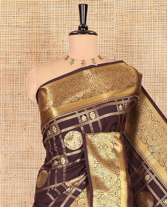 Brown Kanchipuram budget silk saree artfully woven with chakram zari butta enclosed checks all over its body, complemented by zari traditional design border, Mughal-style intricately woven pallu, and paired with a Matching blouse