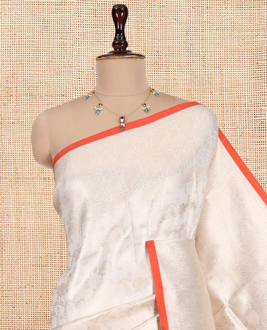 Off-White-Orange Semi-Silk Saree, Adorned with Floral Jacquard Design, a Zari Paisley Border, and a Contrast Blouse