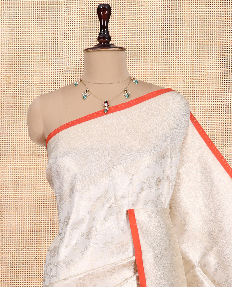 Off-White-Orange Semi-Silk Saree, Adorned with Floral Jacquard Design, a Zari Paisley Border, and a Contrast Blouse