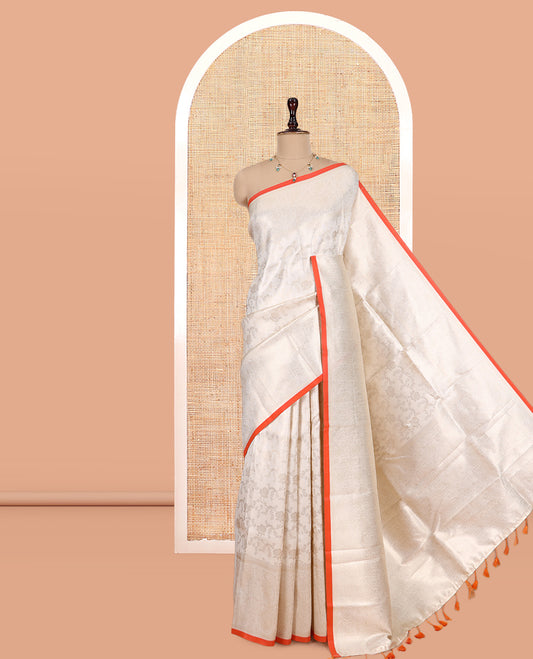 Off-White-Orange Semi-Silk Saree, Adorned with Floral Jacquard Design, a Zari Paisley Border, and a Contrast Blouse