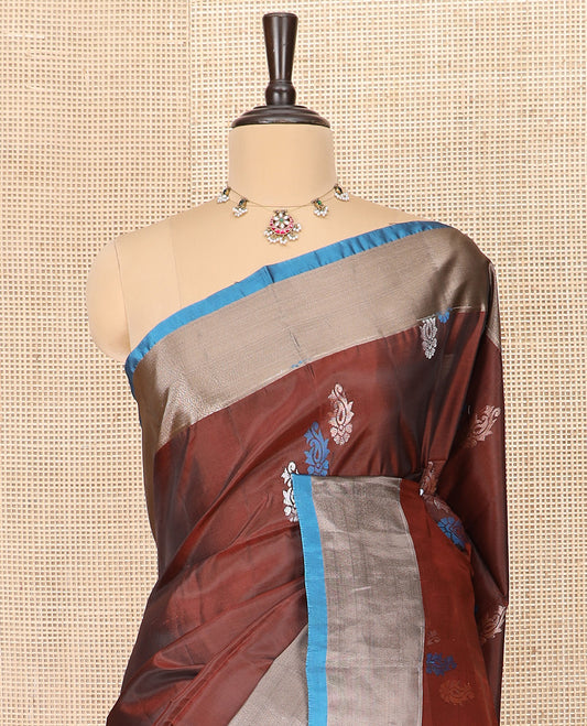 Brown Semi Uppada Saree Graced with Paisley Buttas, Complemented by a Contrasting Bavanji Border, Artfully Detailed Pallu of Intricate Zari Designs, and Paired with a Contrast Blouse