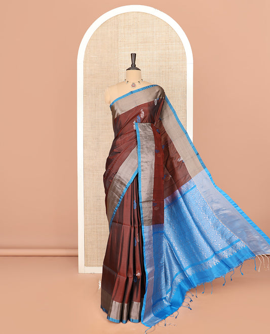Brown Semi Uppada Saree Graced with Paisley Buttas, Complemented by a Contrasting Bavanji Border, Artfully Detailed Pallu of Intricate Zari Designs, and Paired with a Contrast Blouse