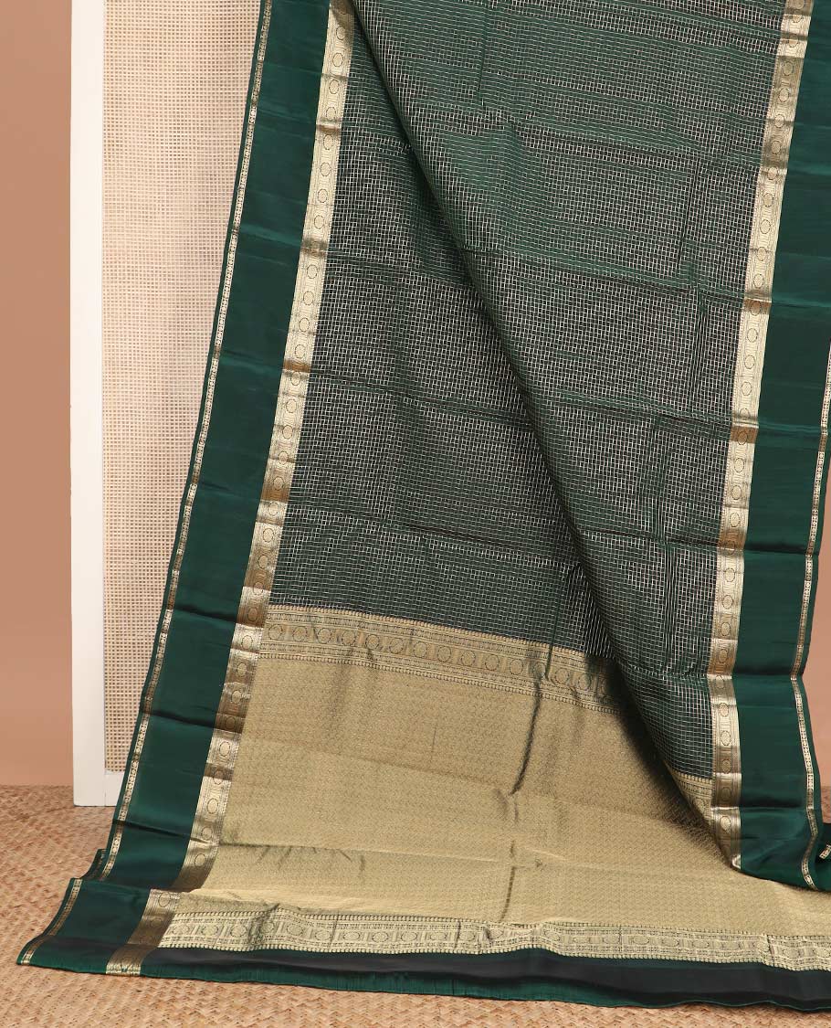 Green checked Vasundhara silk mix saree, zari border of manga, muthu, banaras, chakram, rudraksham, and diamond patterns, and paiyaadi kattam pallu