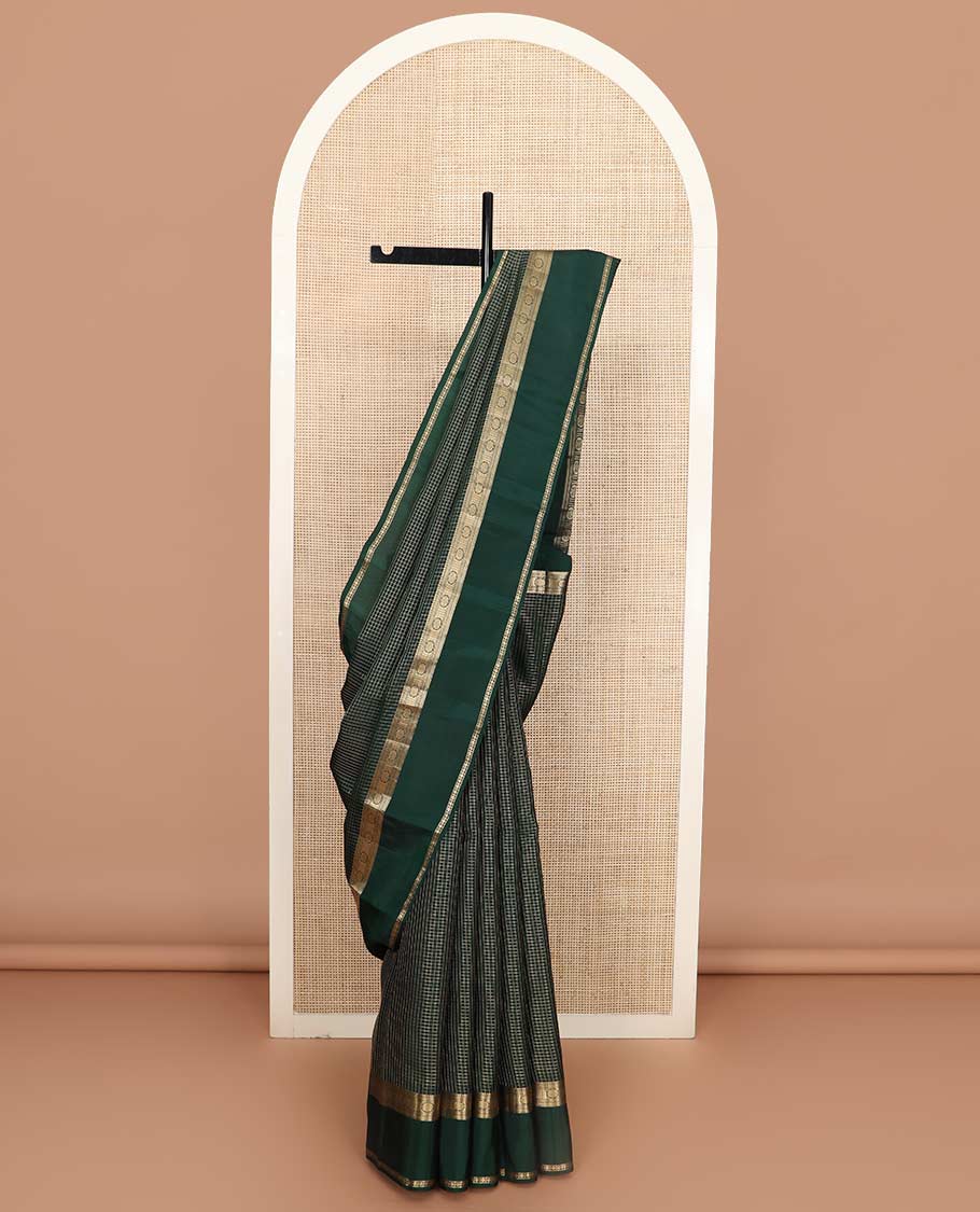 Green checked Vasundhara silk mix saree, zari border of manga, muthu, banaras, chakram, rudraksham, and diamond patterns, and paiyaadi kattam pallu