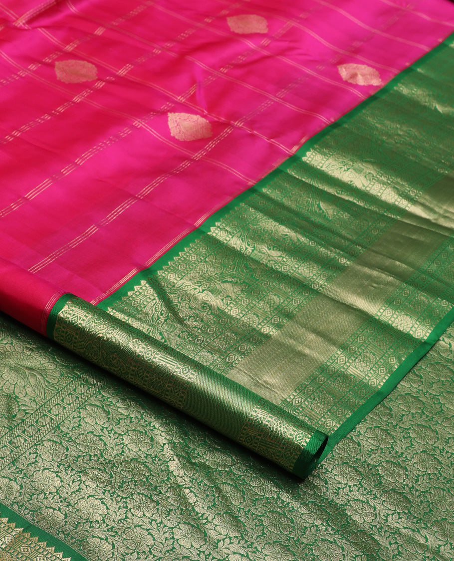 Dark pink zari buttas and checked silk saree, contrast border of rekku, muthu, diamond, yaanai, and chakram designs, and floral jaal pallu