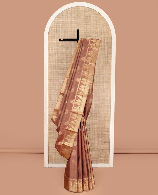 Pinkish Brown Vasundhara Silk Saree, Elevated with Zari Buttas All Over Its Body, Highlighted by Zari Border of Rekku, Muthu, Vangi, and Bride-Groom Suyamvaram Designs, Pallu of Zari Designs, and Paired with a Matching Blouse