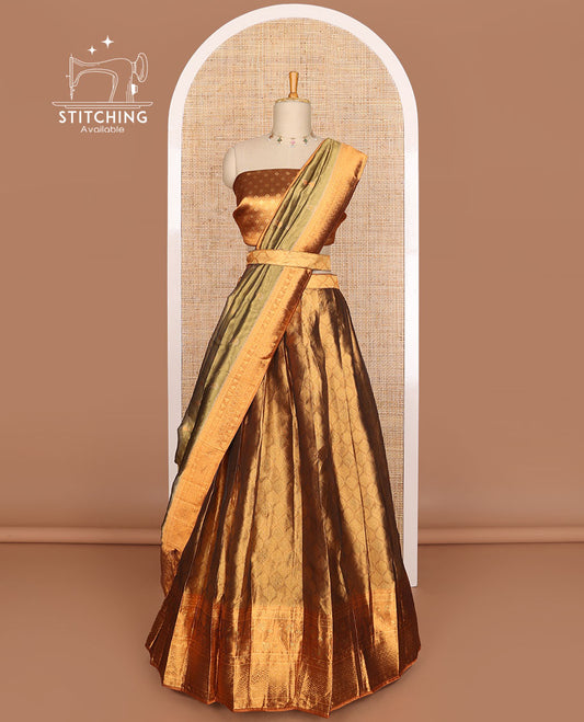 Brown ogee design tissue half saree with contrast zari design border, zari design blouse & floral design dhavani