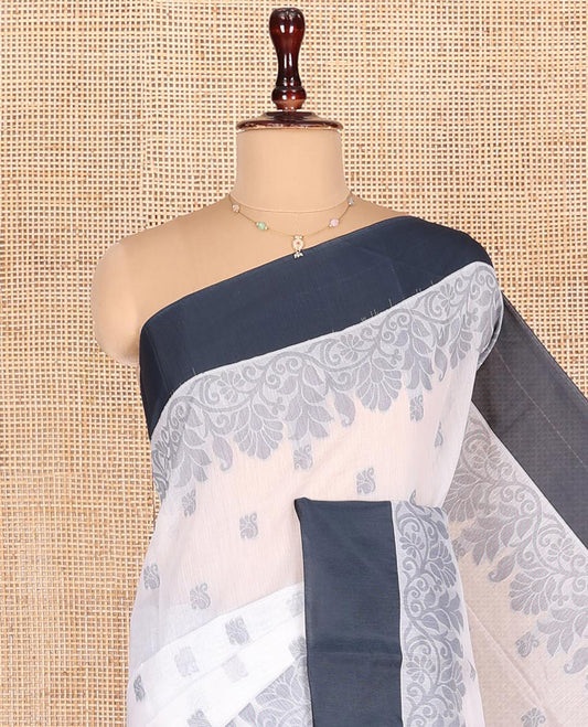 White Semi-Silk Cotton Saree, Sparsely Woven with Buttas and Floral Designs All Over Its Body, Complemented by Contrast Border, Sparsely Woven Pallu of Floral Jaal Designs, and Paired with a Matching Blouse