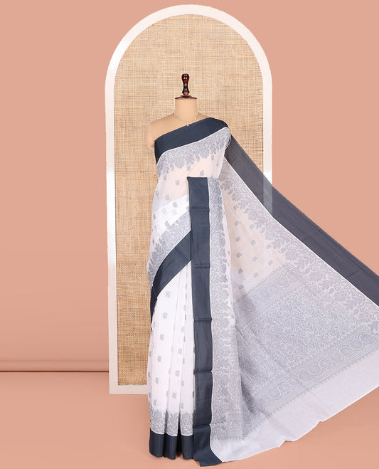 White Semi-Silk Cotton Saree, Sparsely Woven with Buttas and Floral Designs All Over Its Body, Complemented by Contrast Border, Sparsely Woven Pallu of Floral Jaal Designs, and Paired with a Matching Blouse