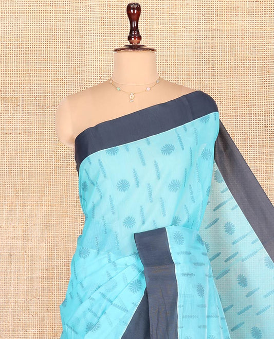 Blue Semi-Silk Cotton Saree, Subtly Adorned with Buttas on Its Body, Complemented by Contrast Border, Sparsely Designed Pallu of Geometric Designs, and Paired with a Matching Blouse